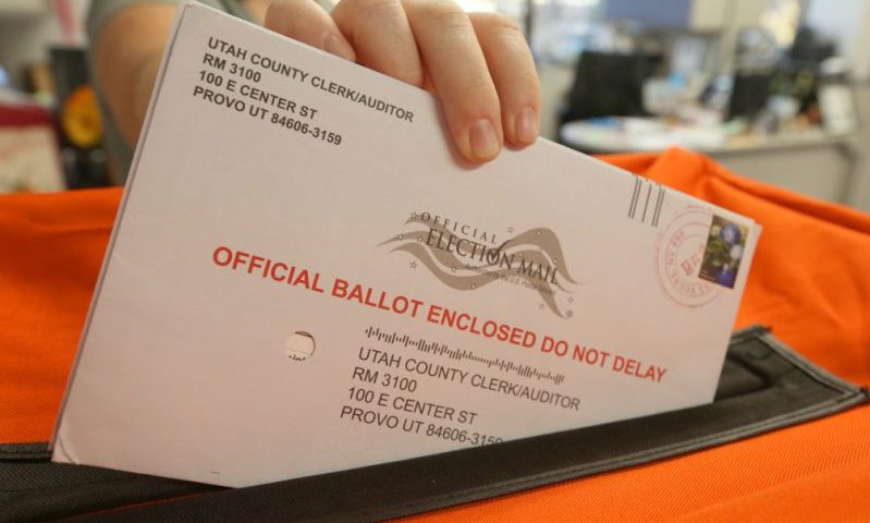PROVO, UT - November 6: A employee at the Utah County Election office puts mail in ballots into a container to register the vote in the midterm elections on November 6, 2018 in Provo, Utah. Utah early voting has been the highest ever in Utah's midterm elections. One of the main proportions on the ballot in Utah is whether Utah will legalize medical marijuana. (Photo by George Frey/Getty Images)
