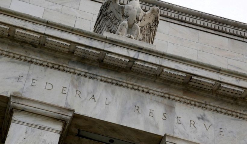 An eagle tops the U.S. Federal Reserve building's facade in Washington, July 31, 2013. REUTERS/Jonathan Ernst