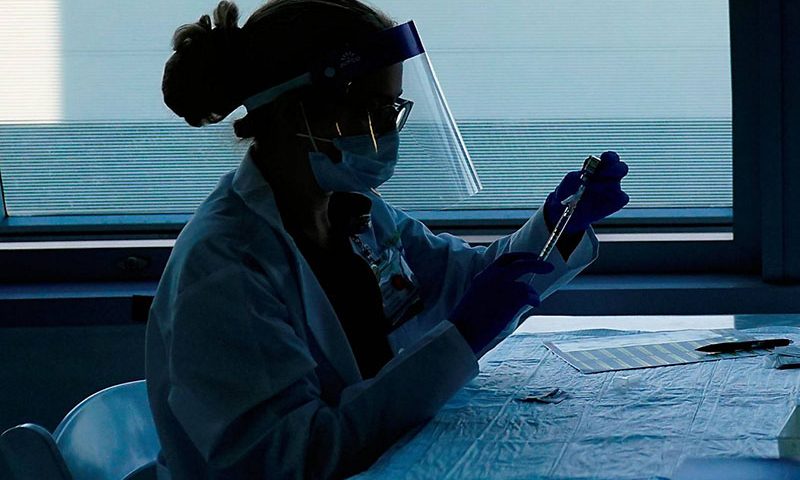 In this Jan. 7, 2021, file photo, health care workers prepare the Pfizer-BioNTech COVID-19 vaccine for medical workers at a hospital in Orange, Calif. (AP Photo/Jae C. Hong)