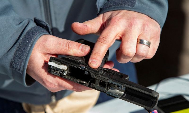 Rob Regent of SGW Designworks breaks down the inner working of the 9mm smart gun, which works only for the designated user, during a presentation for shareholders and potential investors in Boise, Idaho, U.S. January 7, 2022. REUTERS/Brian Losness