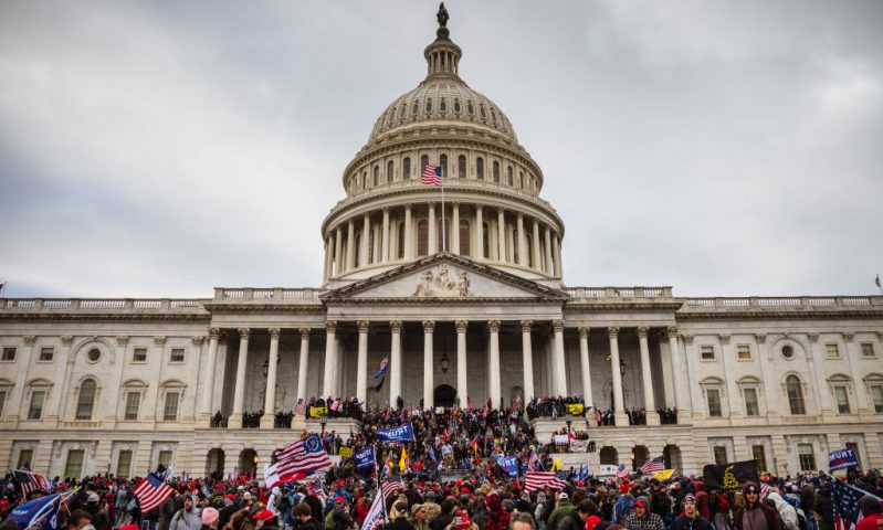 WASHINGTON, DC - JANUARY 06: A large group of pro-Trump protesters stand on the East steps of the Capitol Building after storming its grounds on January 6, 2021 in Washington, DC. A pro-Trump mob stormed the Capitol, breaking windows and clashing with police officers. Trump supporters gathered in the nation's capital today to protest the ratification of President-elect Joe Biden's Electoral College victory over President Trump in the 2020 election. (Photo by Jon Cherry/Getty Images)