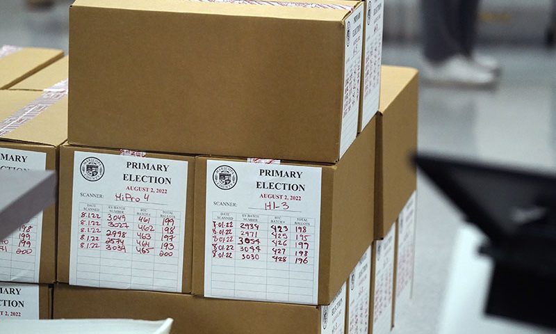 Boxes of ballots sit in the Maricopa County Recorder and Elections Department offices after Arizona's primary election Wednesday, Aug. 3, 2022, in Phoenix. (AP Photo/Ross D. Franklin)