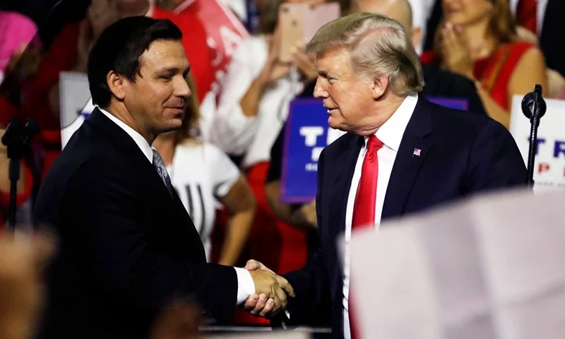 In this July 31, 2018, file photo, President Donald Trump, right, shakes hands with Florida Republican gubernatorial candidate Ron DeSantis during a rally in Tampa, Fla. Florida voters are going to the polls, Tuesday, Aug. 28, 2018, to select nominees to replace Republican Gov. Rick Scott in an election that’s caught the attention of Trump. (AP Photo/Chris O'Meara, File)(AP)