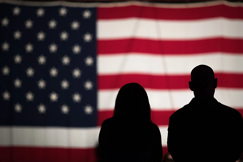 WASHINGTON, DC - MAY 27: A couple views a large American flag set up on the National Mall, May 27, 2016, in Washington, DC. Rolling Thunder members and supporters will participate in a motorcycle rally on Sunday afternoon in Washington. Rolling Thunder is an advocacy group that seeks to bring awareness to prisoners of war (POWs) and missing in action (MIA) service members of all U.S. wars. (Photo by Drew Angerer/Getty Images)