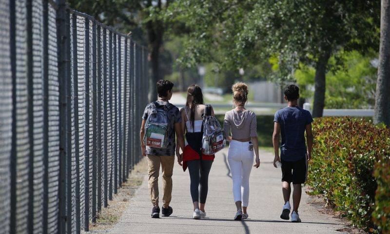 PARKLAND, FL - APRIL 20: Students from Marjory Stoneman Douglas High School, where 17 classmates and teachers were killed during a mass shooting, leave school together for the National School Walkout on April 20, 2018 in Parkland, Florida. Students from around the nation joined in school walkouts against gun violence on the 19th anniversary of the shooting at Columbine High School in Colorado where 13 people were killed. (Photo by Joe Raedle/Getty Images)