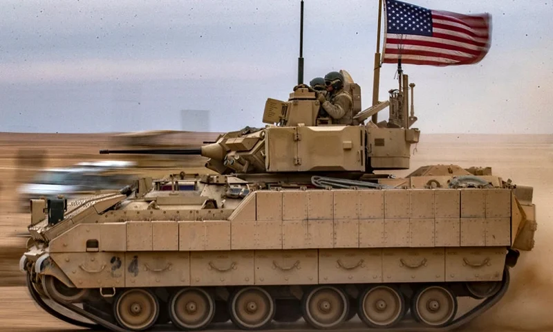 A US Bradley Fighting Vehicle (BFV) drives during a joint military exercise between the Syrian Democratic Forces (SDF) and the US-led international coalition against the Islamic State (IS) group, in the countryside of Deir Ezzor in northeastern Syria on December 7, 2021. (Photo by Delil souleiman / AFP) (Photo by DELIL SOULEIMAN/AFP via Getty Images)