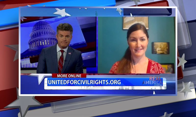 Video still from Joanna Aud's interview with Real America on One America News Network