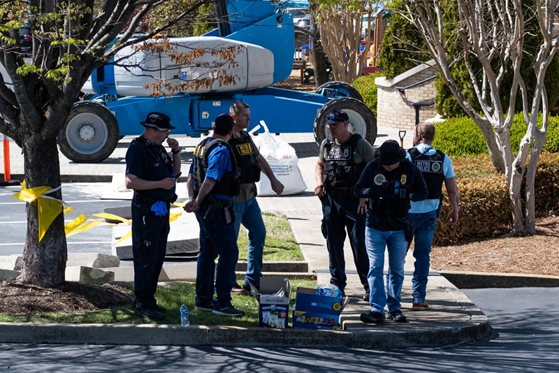 NASHVILLE, TN - MARCH 27: Law enforcement officers stand outside of Woodmont Baptist Church while waiting for children to be reunited with their families after a mass shooting at The Covenant School on March 27, 2023 in Nashville, Tennessee. According to initial reports, three students and three adults were killed by the shooter, a 28-year-old woman. The shooter was killed by police responding to the scene. (Photo by Seth Herald/Getty Images)