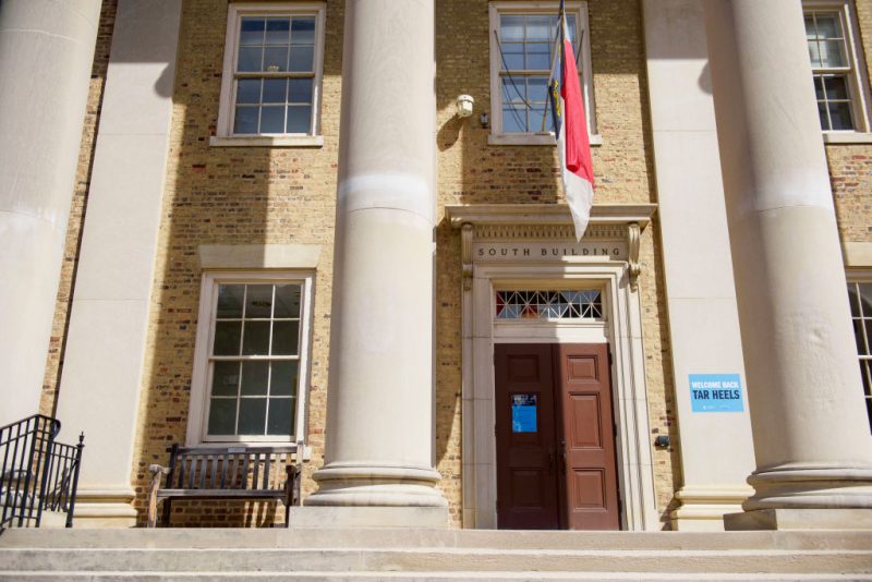 A mostly empty campus with welcome back and COVID-19-19 protocol signs is seen at the University of North Carolina at Chapel Hill on August 18, 2020 in Chapel Hill, North Carolina. The school halted in-person classes and reverted back to online courses after a rise in the number of COVID-19 cases over the past week. (Photo by Melissa Sue Gerrits/Getty Images)