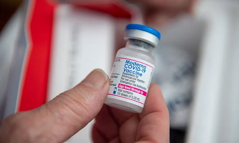 A medical workers holds a vial of the new Moderna child Covid-19 vaccine before filling syringes with it at Temple Beth Shalom in Needham, Massachusetts on June 21, 2022. The temple was one of the first sites in the state to offer vaccinations to anyone in the public. - US health authorities on Saturday cleared the Pfizer and Moderna Covid-19 vaccines for children aged five and younger, in a move President Joe Biden greeted as a "monumental step" in the fight against the virus. (Photo by Joseph Prezioso / AFP) (Photo by JOSEPH PREZIOSO/AFP via Getty Images)