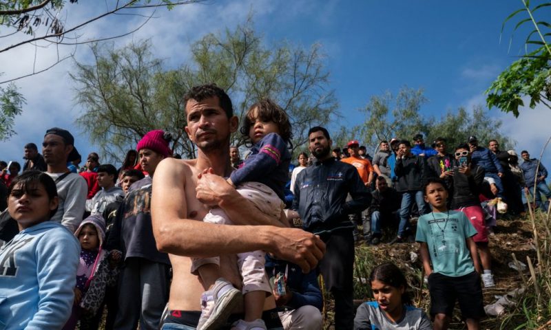 Venezuelan asylum seeker Jehan Carlo Ramirez carries his daughter Joannys S. Ramirez, 2, before they cross the Rio Grande into Brownsville, Texas, the day after Title 42 had been expected to be lifted but now the decision has been postponed for December 27th, in Matamoros, Tamaulipas, Mexico on December 22, 2022. - The US Supreme Court halted December 19, 2022 the imminent scrapping of a key policy used since Donald Trump's administration to block migrants at the southwest border, amid worries over a surge in undocumented immigrants. An order signed by Chief Justice John Roberts placed an emergency stay on the removal planned for December 21, 2022 of Title 42, which allowed the government to use Covid-19 safety protocols to summarily block the entry of millions of migrants. (Photo by VERONICA G. CARDENAS / AFP) (Photo by VERONICA G. CARDENAS/AFP via Getty Images)