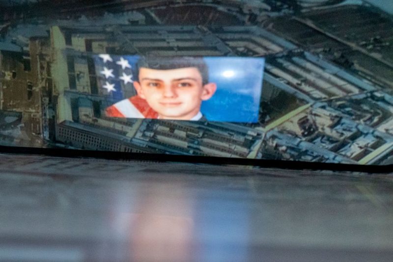 This photo illustration created on April 13, 2023, shows the suspect, national guardsman Jack Teixeira, reflected in an image of the Pentagon in Washington, DC. - FBI agents on Thursday arrested a young national guardsman suspected of being behind a major leak of sensitive US government secrets -- including about the Ukraine war. US Attorney General Merrick Garland announced the arrest made "in connection with an investigation into alleged unauthorized removal, retention and transmission of classified national defense information." (Photo by Stefani REYNOLDS / AFP) (Photo by STEFANI REYNOLDS/AFP via Getty Images)