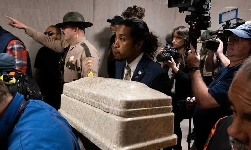 Democratic representative Justin Jones of Nashville walks with a casket in hand, representing the lives lost in a mass shooting, during a rally for gun reform in Nashville, Tennessee on April 17, 2023. - The rally was apart of Moral Monday events and to call for gun reform in the wake of the mass shooting that happened in Nashville on March 27. Democrats Justin Jones and Justin Pearson, both of whom are Black, were expelled by Republican lawmakers April 6, 2023 after they disrupted the assembly session, demanding restrictions on firearms in the wake of a deadly mass shooting at an elementary school in the city of Nashville. (Photo by SETH HERALD / AFP) (Photo by SETH HERALD/AFP via Getty Images)