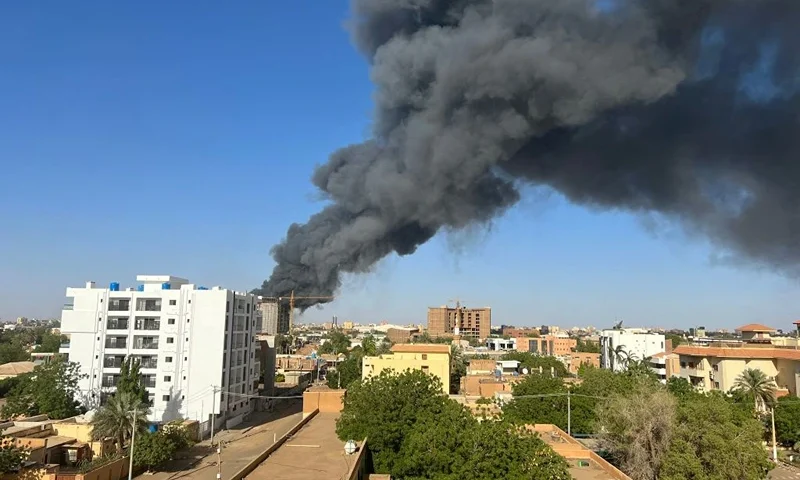 A column of smoke rises behind buildings near the airport area in Khartoum on April 19, 2023, amid fighting between the army and paramilitaries following the collapse of a 24-hour truce. (Photo by AFP) (Photo by -/AFP via Getty Images)