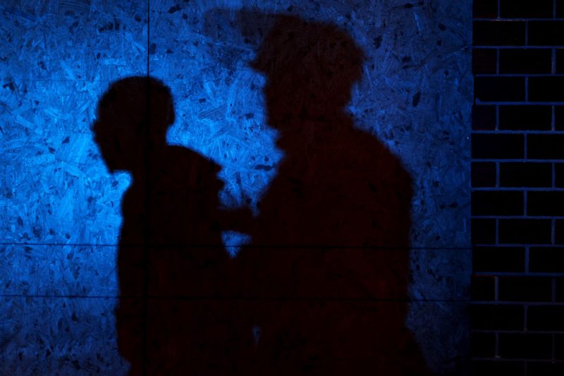 The shadow of a Louisville Police officers arresting a demonstrator is seen on a wall on September 23, 2020 in Louisville, Kentucky. A Kentucky grand jury indicted one police officer involved in the shooting of Breonna Taylor with three counts of wanton endangerment. No officers were indicted on charges in connection to Taylor's death. Two police officers were shot during protests that broke out after the grand jury announcement. (Photo by Michael M. Santiago/Getty Images)