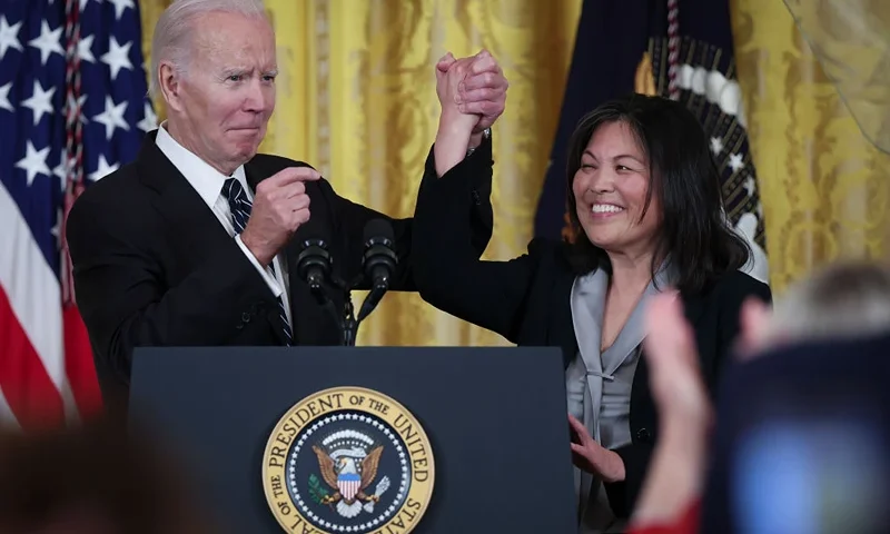 WASHINGTON, DC - MARCH 01: U.S. President Joe Biden links arms with Julie Su, his nominee to be the next Secretary of Labor during an event in the East Room of the White House March 1, 2023 in Washington, DC. Su will replace the current Secretary of Labor, Marty Walsh. (Photo by Win McNamee/Getty Images)