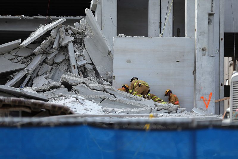 Miami-Dade Rescue workers prepare to pull a body out of the rubble of a four-story parking garage that was under construction and collapsed at the Miami Dade College’s West Campus on October 10, 2012 in Doral, Florida. Early reports indicate that one person was killed in the collapse, at least seven people injured and one person may still be trapped in the rubble. (Photo by Joe Raedle/Getty Images)
