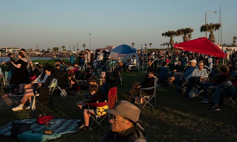 People pass their time as they wait for the SpaceX Starship rocket to be launched in South Padre Island, Texas on April 17, 2023. - SpaceX on Monday postponed the first test flight of Starship, the most powerful rocket ever built. Liftoff of the giant rocket was called off just minutes ahead of the scheduled launch time because of a pressurization issue, SpaceX officials said. (Photo by VERONICA G. CARDENAS/AFP via Getty Images)