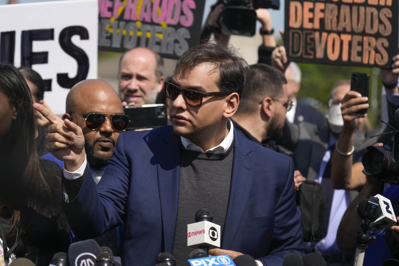 U.S. Rep. George Santos answers questions for the media outside federal court, Wednesday, May 10, 2023, in Central Islip, N.Y. Santos pleaded not guilty to charges alleging a financial fraud at the heart of a political campaign built on dubious boasts about his personal wealth and business success. (AP Photo/Seth Wenig)