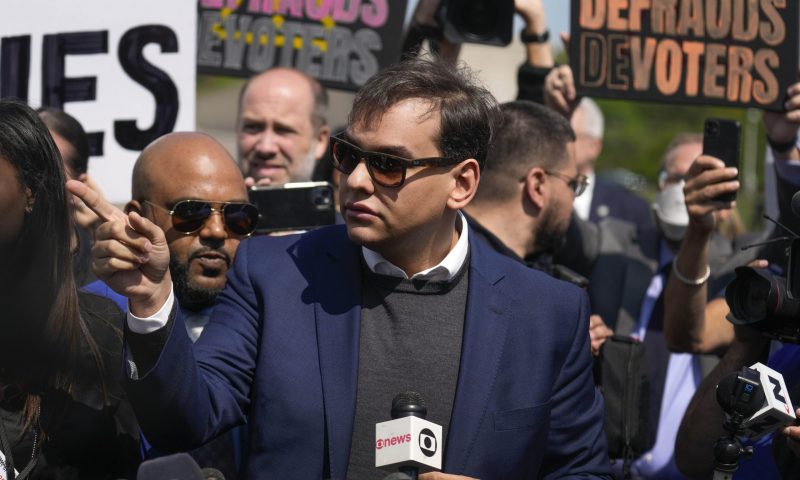 U.S. Rep. George Santos answers questions for the media outside federal court, Wednesday, May 10, 2023, in Central Islip, N.Y. Santos pleaded not guilty to charges alleging a financial fraud at the heart of a political campaign built on dubious boasts about his personal wealth and business success. (AP Photo/Seth Wenig)