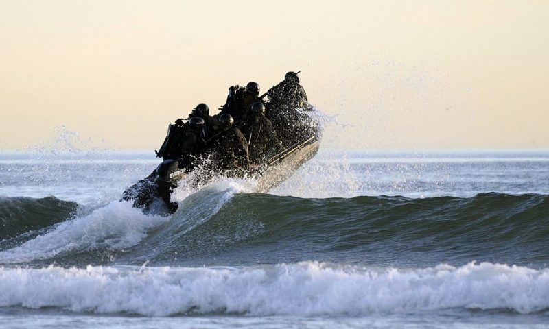 CORONADO, CA - OCTOBER 28: (EDITORS NOTE: Image has been reviewed by U.S. Military prior to transmission.) In this handout provided by the U.S. Navy, Students in Sea Air and Land (SEAL) qualification training navigate the surf off the cost of Coronado during a maritime operations training exercise October 28, 2010 in Coronado, California. The 26-week program takes students from a very basic level, to a more advanced degree of technical and tactical operations. The Navy SEALs are the maritime component of U.S. Special Operations Forces and are trained to conduct a variety of operations from the sea, air and land. (Photo by Blake Midnight/US Navy via Getty Images)