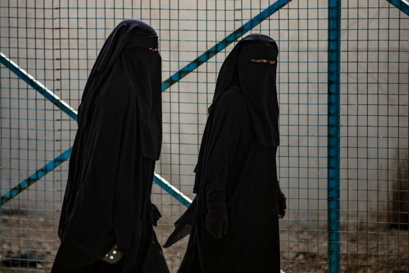 Women walk at the Kurdish-run al-Hol camp which holds suspected relatives of Islamic State (IS) group fighters, in Hasakeh governorate of northeastern Syria, on March 3, 2021. - At least 31 killings have rocked al-Hol camp since early January, a Kurdish official said today, with aid groups warning of a "nightmare". It was the latest evidence of deteriorating security at the camp in the Kurdish-run northeast, where Medecins Sans Frontieres (MSF) had to temporarily suspend operations this week after the killing of one of its team members. (Photo by Delil SOULEIMAN / AFP) (Photo by DELIL SOULEIMAN/AFP via Getty Images)