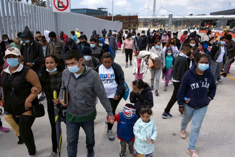 Migrants and asylum seekers awl after a demonstration at the San Ysidro crossing port asking US authorities to allow them to start their migration process in Tijuana, Baja California state, Mexico on March 23, 2021. - Migrants out of MPP program are stranded along the US-Mexico border without knowing when or how they will be able to start their migratory process with US authorities. (Photo by Guillermo Arias / AFP) (Photo by GUILLERMO ARIAS/AFP via Getty Images)