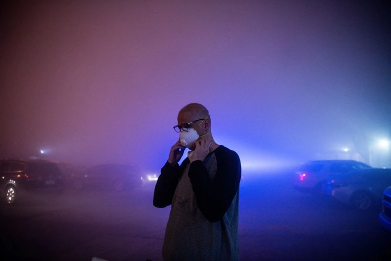 A man stands in a cloud of dust after watching the rest of the Champlain South tower being demolished by a controlled explosion in Surfside, Florida, north of Miami Beach, late on July 4, 2021. - A controlled explosion brought down the unstable remains of the collapsed apartment block in Florida late on July 4 ahead of a threatening tropical storm as rescuers prepare to resume searching for victims. (Photo by CHANDAN KHANNA / AFP) (Photo by CHANDAN KHANNA/AFP via Getty Images)