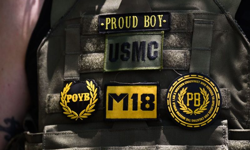 Counter protesters wearing the yellow and black colors and insignia of the Proud Boys gather outside the National Rifle Association (NRA) Annual Meeting at the George R. Brown Convention Center in Houston, Texas on May 28, 2022. - America's powerful National Rifle Association kicked off a major convention in Houston Friday, days after the horrific massacre of children at a Texas elementary school, but a string of high-profile no-shows underscored deep unease at the timing of the gun lobby event. (Photo by Patrick T. FALLON / AFP) (Photo by PATRICK T. FALLON/AFP via Getty Images)