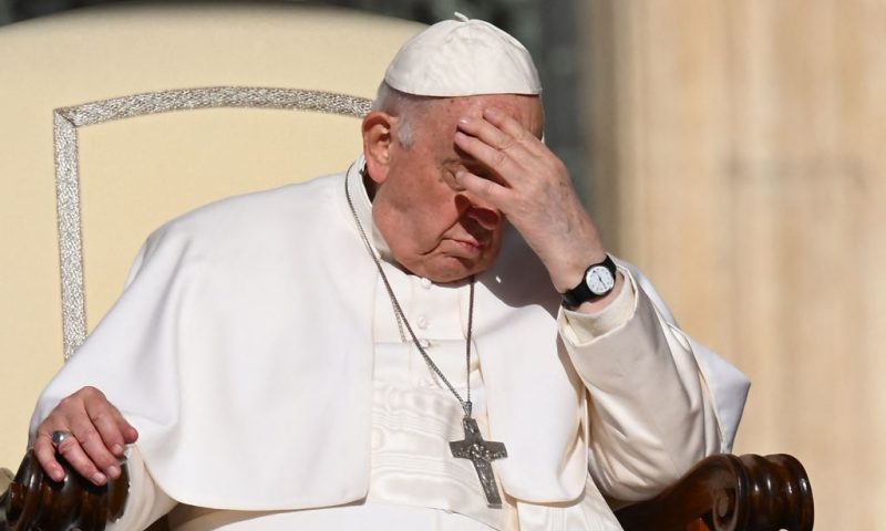 Pope Francis protects his face from the sun at the start of the weekly general audience on April 12, 2023 at St. Peter's square in The Vatican. (Photo by Vincenzo PINTO / AFP) (Photo by VINCENZO PINTO/AFP via Getty Images)
