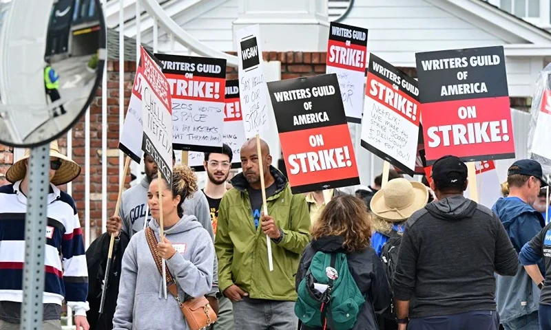 Writers walk the picket line on the third day of the television and movie writers' strike outside of Amazon Studios in Culver City, California, on May 3, 2023. - More than 11,000 Hollywood television and movie writers are on their first strike since 2007 after talks with studios and streamers over pay and working conditions failed to clinch a deal. (Photo by Frederic J. BROWN / AFP) (Photo by FREDERIC J. BROWN/AFP via Getty Images)