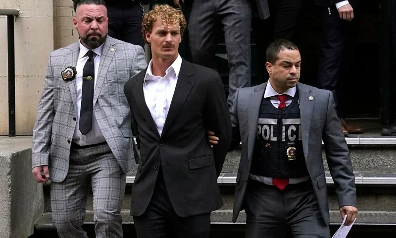 US Marine veteran Daniel Penny (C) is walked out of the New York Police Department 5th Precinct in Lower Manhattan, May 12, 2023 on his way to a arraignment after he surrendered to authorities after being charged with 2nd Degree Manslaughter in the chokehold death of Jordan Neely. The death of Jordan Neely -- widely identified as a Michael Jackson impersonator who often performed on the train -- earlier this month sparked outrage. (Photo by TIMOTHY A. CLARY / AFP) (Photo by TIMOTHY A. CLARY/AFP via Getty Images)