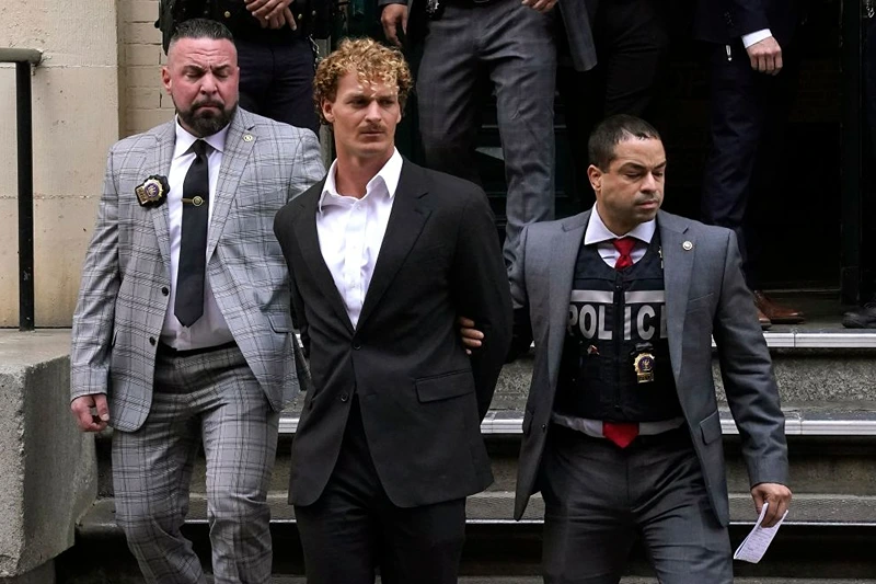 US Marine veteran Daniel Penny (C) is walked out of the New York Police Department 5th Precinct in Lower Manhattan, May 12, 2023 on his way to a arraignment after he surrendered to authorities after being charged with 2nd Degree Manslaughter in the chokehold death of Jordan Neely. The death of Jordan Neely -- widely identified as a Michael Jackson impersonator who often performed on the train -- earlier this month sparked outrage. (Photo by TIMOTHY A. CLARY / AFP) (Photo by TIMOTHY A. CLARY/AFP via Getty Images)
