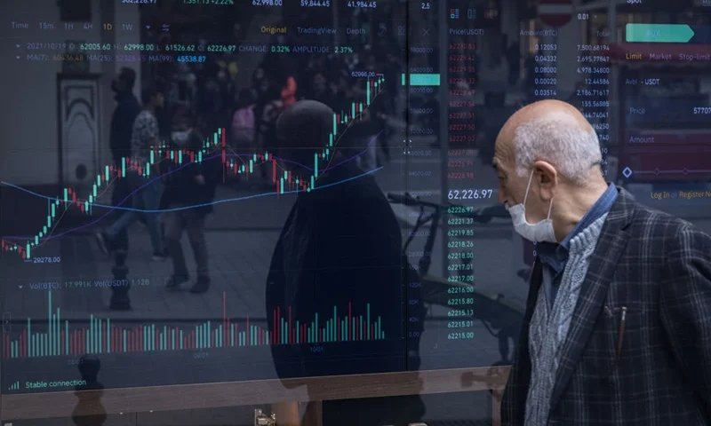ISTANBUL, TURKEY - OCTOBER 19: A man looks at the Bitcoin trading graph in a window of a cryptocurrency exchange office on October 19, 2021 in Istanbul, Turkey. The number of Bitcoin and cryptocurrency exchanges have increased across Istanbul as cryptocurrency investing continues to boom in Turkey. Many investors see cryptocurrency's growth as a shelter against inflation and the depreciating Lira. Turkey's Lira has lost 20% of it's value this year as Bitcoin approaches it's all time high on the back of today's historic debut of the first Bitcoin futures ETF on the NYSE. (Photo by Chris McGrath/Getty Images)