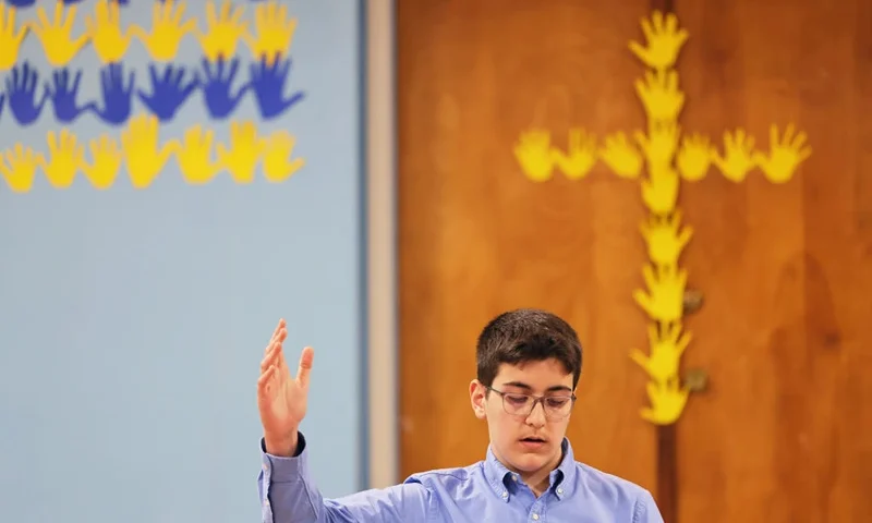 NEW YORK, NEW YORK - MARCH 28: Kevin Corraj, an eighth grader, leads students in a prayer during a prayer service for Ukraine at St. Brendan Catholic School on March 28, 2022 in the Bronx borough in New York City. Students from all 170 catholic schools in the Archdiocese of New York, held a prayer service for peace in Ukraine. (Photo by Michael M. Santiago/Getty Images)