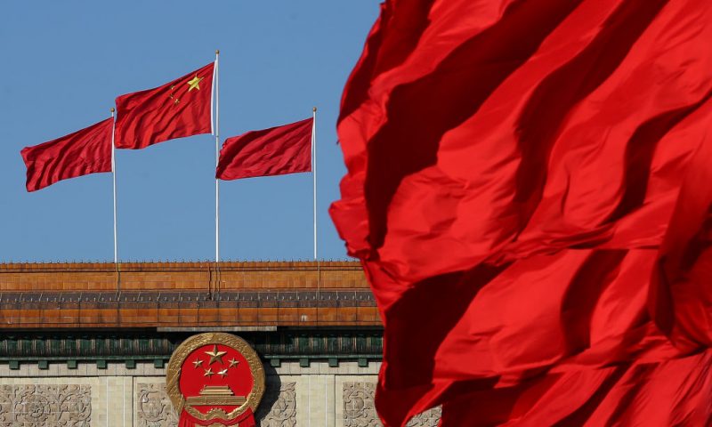 BEIJING, CHINA - MARCH 04: Red flags flutter in the wind near the Chinese national emblem outside the Great Hall of the People where sessions of the Chinese People's Political Consultative Conference and National People's Congress are being held on March 4, 2014 in Beijing, China. "Based on our history and experience, we believe that peace can only be maintained by strength," National People's Congress spokesperson Fu Ying respond to a question concerning China's growing military power. (Photo by Feng Li/Getty Images)