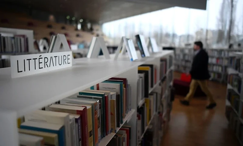 A man walks past a section dedicated to literature, during the inauguration of the new multimedia library in Caen, on January 13, 2017. / AFP / DAMIEN MEYER (Photo credit should read DAMIEN MEYER/AFP via Getty Images)