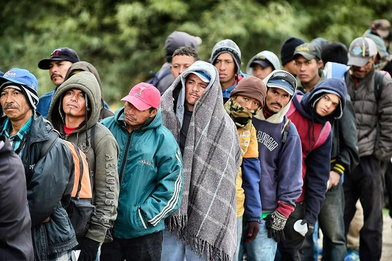 TOPSHOT - Migrants wait to receive food donated by people from the Community Center for Migrant Assistance in the community of Caborca in Sonora state, Mexico, on January 13, 2017. - Hundreds of Central American and Mexican migrants attempt to cross the US border daily. (Photo by ALFREDO ESTRELLA / AFP) (Photo by ALFREDO ESTRELLA/AFP via Getty Images)