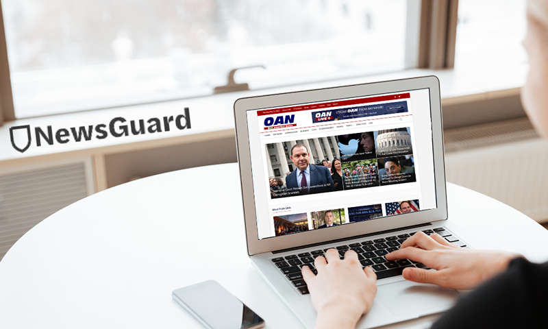 Person browsing OAN homepage on their laptop