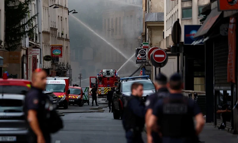 French police secure the area as firefighters work after several buildings on fire following a gas explosion in the fifth arrondissement of Paris, France, June 21, 2023. REUTERS/Gonzalo Fuentes