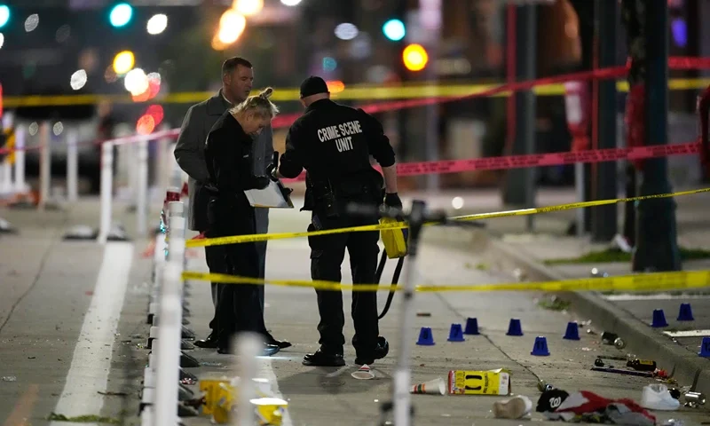Denver Police Department investigators work on the scene of a mass shooting along Market Street between 20th and 21st avenues during a celebration after the Denver Nuggets won the team's first NBA Championship early Tuesday, June 13, 2023, in Denver. (AP Photo/David Zalubowski)