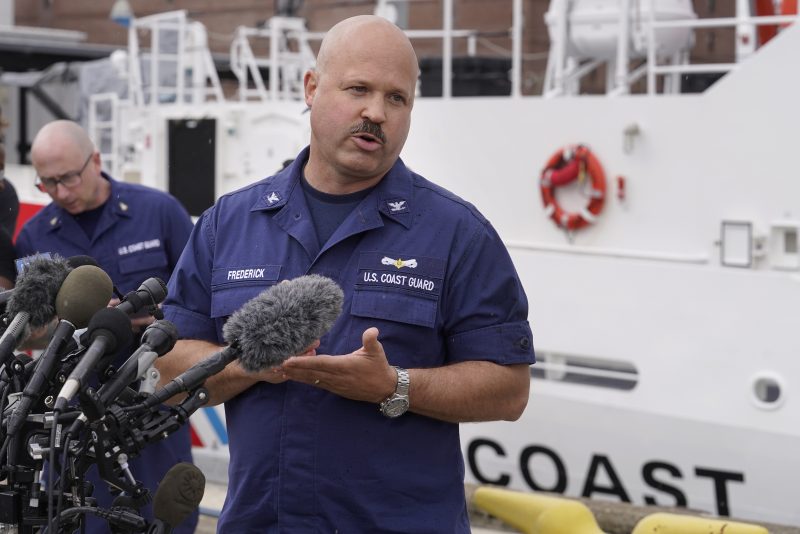 U.S. Coast Guard Capt. Jamie Frederick speaks to reporters during a news conference, Tuesday, June 20, 2023, at Coast Guard Base Boston. The U.S. Coast Guard says a search covering 10,000 square miles (26,000 square kilometers) has turned up no signs of a missing submersible off New England. Authorities made the announcement Tuesday. (AP Photo/Steven Senne)