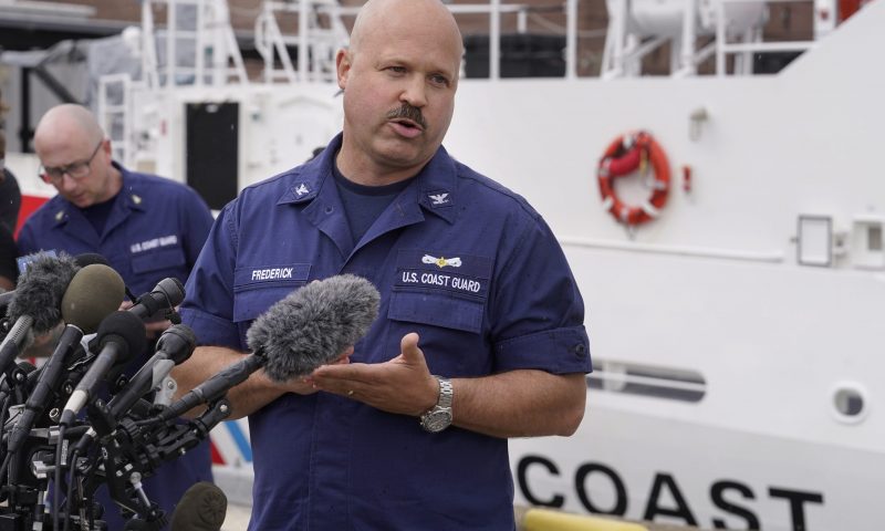 U.S. Coast Guard Capt. Jamie Frederick speaks to reporters during a news conference, Tuesday, June 20, 2023, at Coast Guard Base Boston. The U.S. Coast Guard says a search covering 10,000 square miles (26,000 square kilometers) has turned up no signs of a missing submersible off New England. Authorities made the announcement Tuesday. (AP Photo/Steven Senne)
