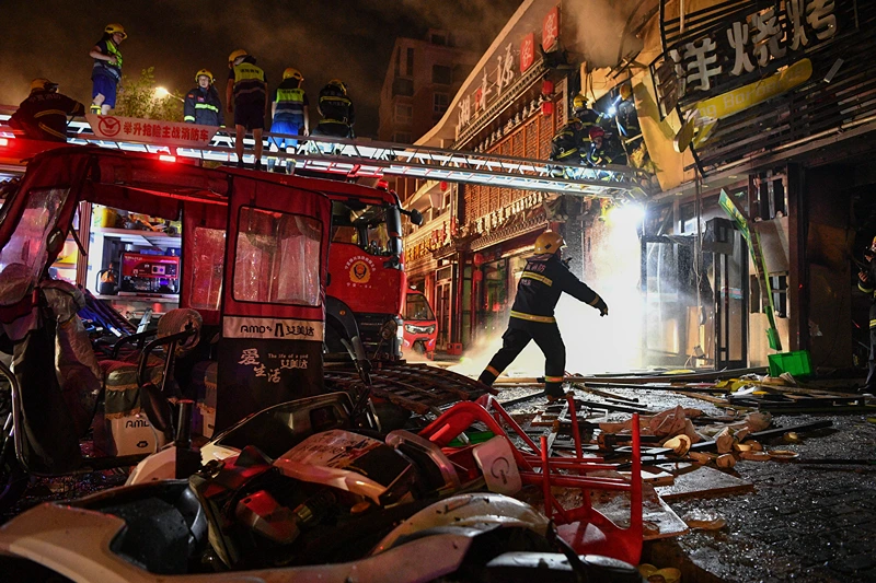 In this photo released by Xinhua News Agency, firefighters work at the site of an explosion at a restaurant in Yinchuan, northwest China's Ningxia Hui Autonomous Region, Wednesday, June 21, 2023. China's president Xi Jinping ordered a national safety campaign on Thursday after a massive cooking gas explosion at a barbecue restaurant in the northwest killed 31 people and injured seven others on the eve of a long holiday weekend. (Wang Peng/Xinhua via AP)