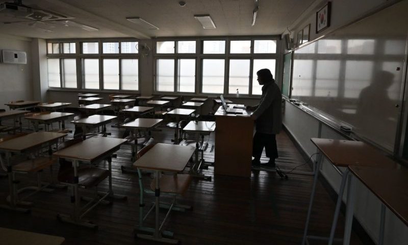 A teacher gives an online class as her students attend a virtual classroom amid concerns over the COVID-19 coronavirus at Seoul Girls' High School in Seoul on April 9, 2020. - South Korea started the new school term on April 9 with online classes for middle and high school senior students after taking a month's break in an effort to prevent the spread of the novel coronavirus. (Photo by Jung Yeon-je / AFP) (Photo by JUNG YEON-JE/AFP via Getty Images)