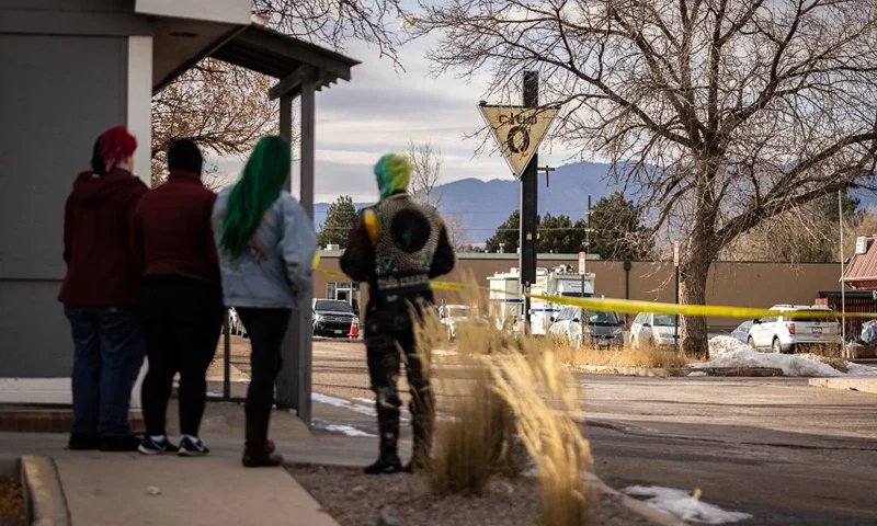 COLORADO SPRINGS, CO - NOVEMBER 23: Mourners stand outside of Club Q on November 23, 2022 in Colorado Springs, Colorado. A gunman opened fire inside the LGBTQ+ club on November 19th, killing 5 and injuring 25 others. (Photo by Chet Strange/Getty Images)