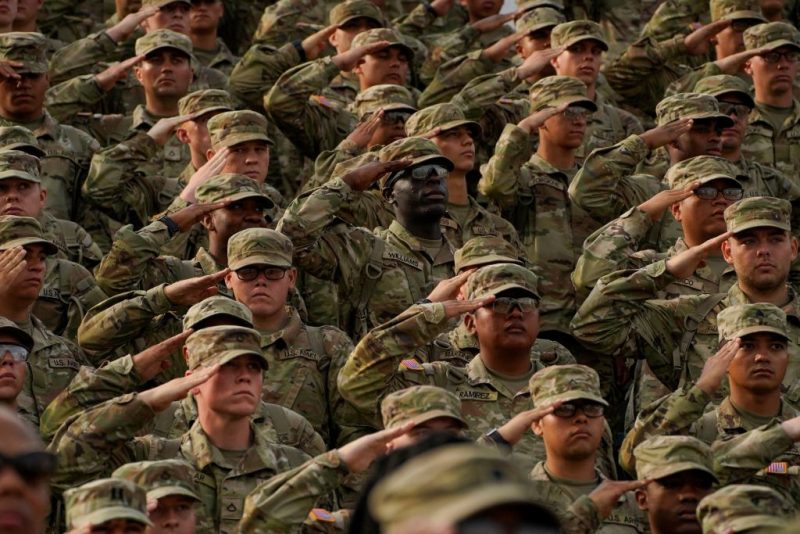 Members of the U.S. Military salute during a ceremony to redesignate Fort Benning as Fort Moore, at Doughboy Stadium in Columbus, Georgia, on May 11, 2023. Calls to rename nine military bases, all of which are located in southern states that seceded and briefly formed the Confederacy, gained momentum during nationwide protests against racism and police brutality that were sparked by the 2020 murder of George Floyd, an African American man who died at the hands of a white police officer in Minneapolis. (Photo by CHENEY ORR / AFP) (Photo by CHENEY ORR/AFP via Getty Images)