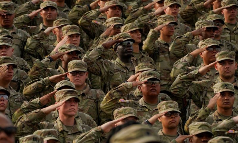 Members of the U.S. Military salute during a ceremony to redesignate Fort Benning as Fort Moore, at Doughboy Stadium in Columbus, Georgia, on May 11, 2023. Calls to rename nine military bases, all of which are located in southern states that seceded and briefly formed the Confederacy, gained momentum during nationwide protests against racism and police brutality that were sparked by the 2020 murder of George Floyd, an African American man who died at the hands of a white police officer in Minneapolis. (Photo by CHENEY ORR / AFP) (Photo by CHENEY ORR/AFP via Getty Images)