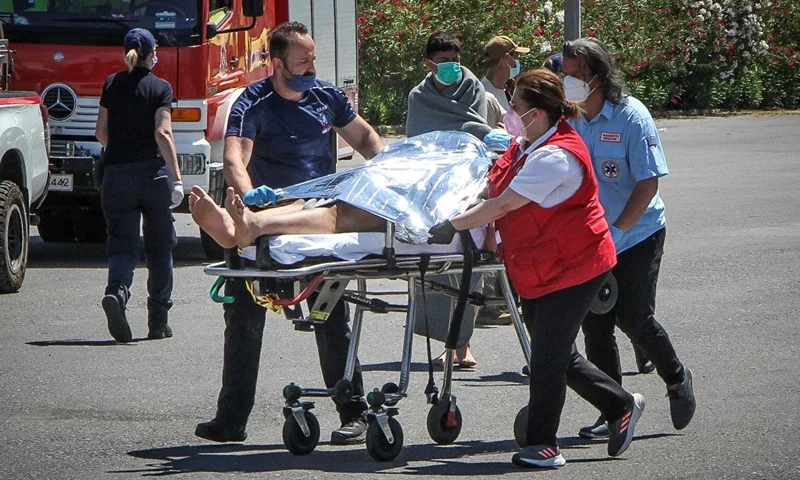 TOPSHOT - Medics carry a survivor on a stretcher, after a boat carrying dozens of migrants sank in international waters in the Ionian Sea, at the port in Kalamata town, on June 14, 2023. At least 59 people died while some 100 people were rescued after the boat capsized. (Photo by STRINGER / Eurokinissi / AFP) / Greece OUT (Photo by STRINGER/Eurokinissi/AFP via Getty Images)
