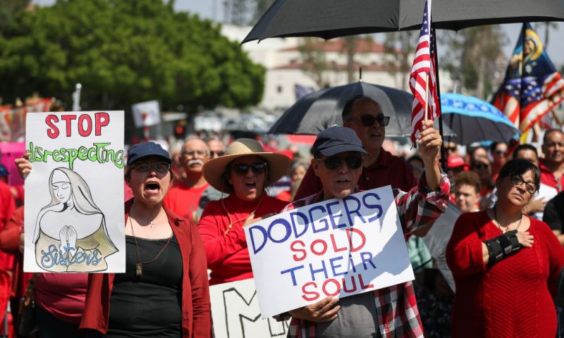 LOS ANGELES, CALIFORNIA - JUNE 16: Protesters hold signs at a Catholics for Catholics event in response to the Dodgers' Pride Night event including the Sisters of Perpetual Indulgence prior to the game between the San Francisco Giants and the Los Angeles Dodgers at Dodger Stadium on June 16, 2023 in Los Angeles, California. (Photo by Meg Oliphant/Getty Images)